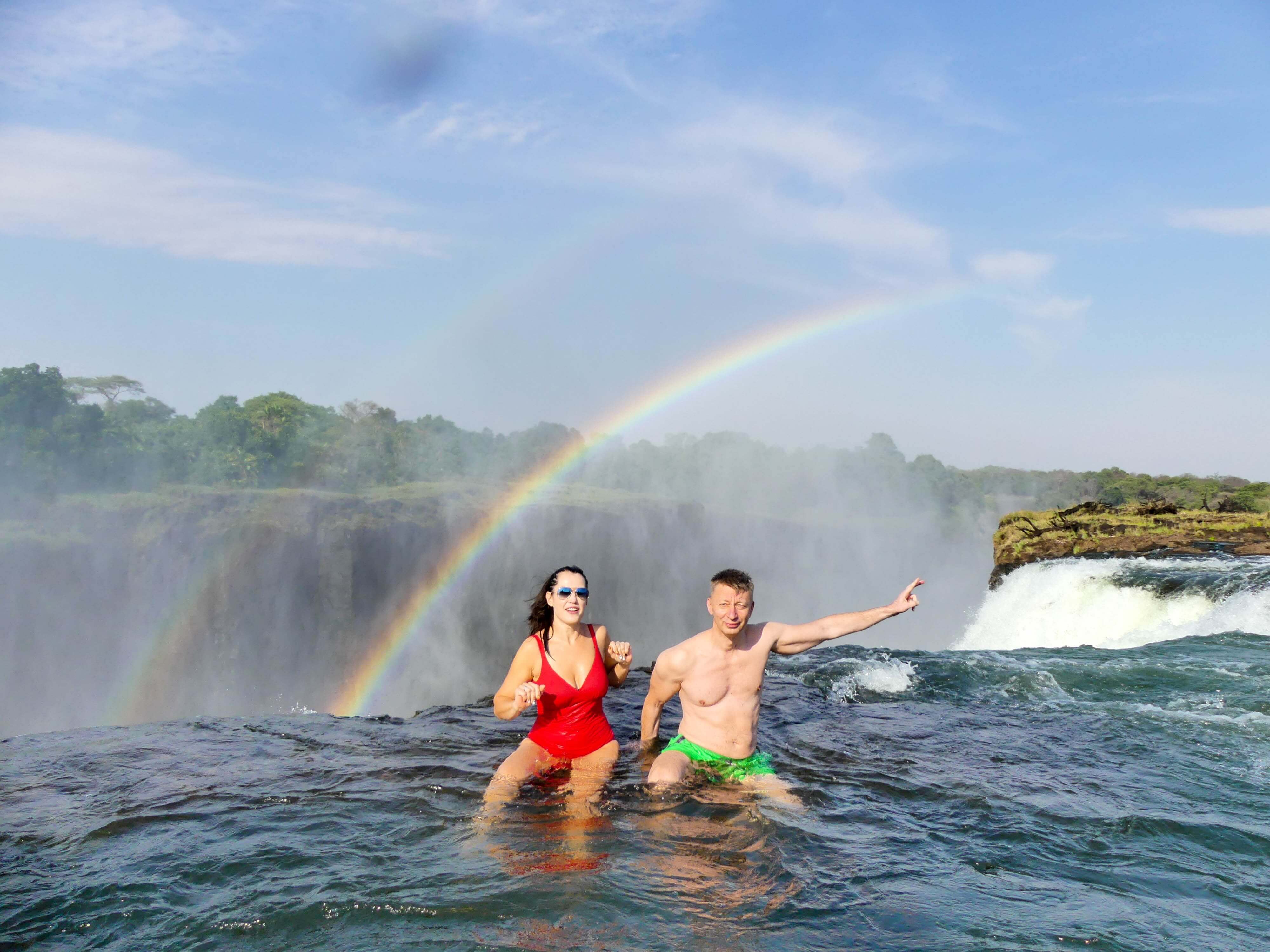 Swimmers at Devil's Pool on the lip of Victoria Falls
